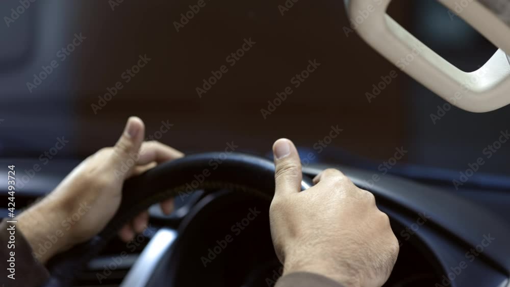 The hand is holding the steering wheel of the car Safe driving. Young