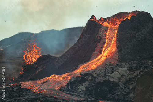 Volcanic eruption in Iceland, lava bursting from the volcano. Expending lava. 