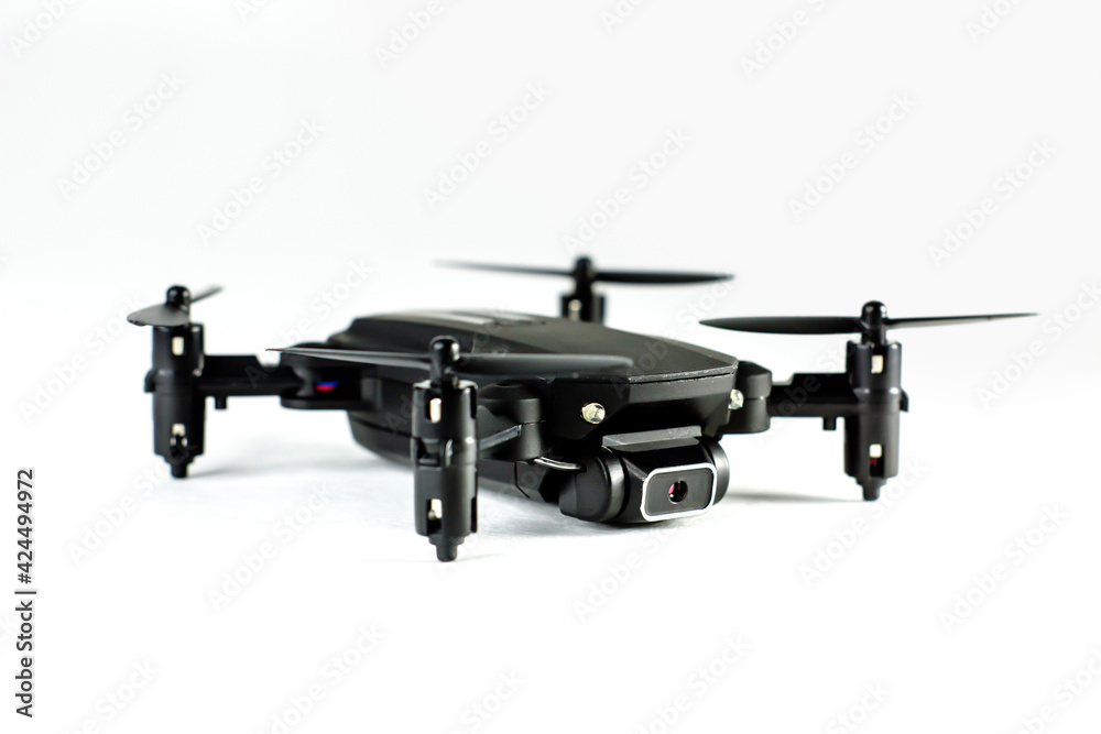 Black mini drone on a white background closeup. Spy technology