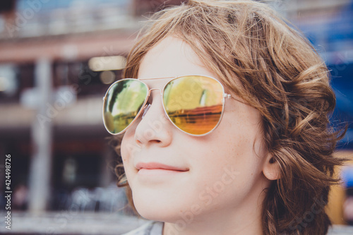 Reflection of the Guggenheim Museum in a boy's sunglasses, Bilbao, Spain photo