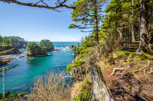 Ocean view with mountains  small island  blue sky and white clouds at summer day.