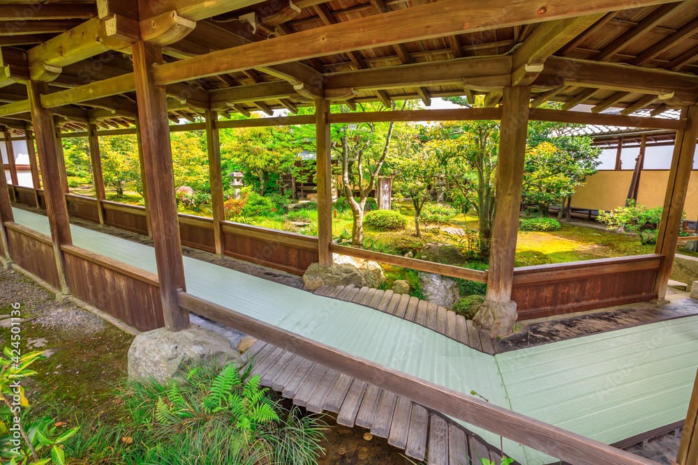 Kyoto, Japan - April 27, 2017: covered corridor that leads to Taho-den hall through the garden of Zen Temple Tenryu-ji in Kyoto, Japan. Tenryuji is most important Temple in Arashiyama. Kyoto, Japan - April 27, 2017: covered corridor that leads to Taho-den hall through the garden of Zen Temple Tenryu-ji in Kyoto, Japan. Tenryuji is most important Temple in Arashiyama.