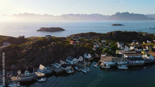 Aerial view of a village, in Lofoten archipelago, sunset, in Norway - reverse, drone shot photo