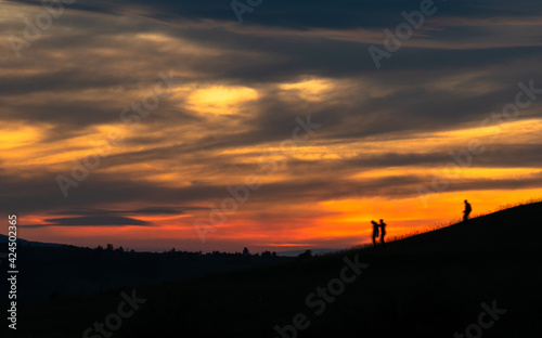 silhouette of a person walking on a hill © Ammar