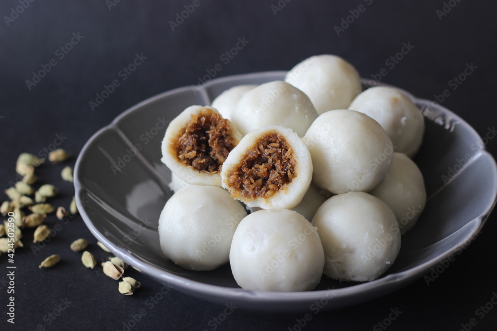 Steamed dumplings made with rice flour dough and stuffed with a filling of coconut and jaggery. Steamed dumplings made with rice flour dough and stuffed with a filling of coconut and jaggery.