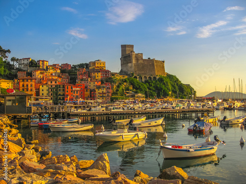 Lerici , Italy- June 5, 2010: San Giorgio castle of Lerici town from the of Gulf of Poets with sailing boats and motor boats at sunset. La Spezia province, Ligurian Coast of Italy. Scenic Lerici Port 