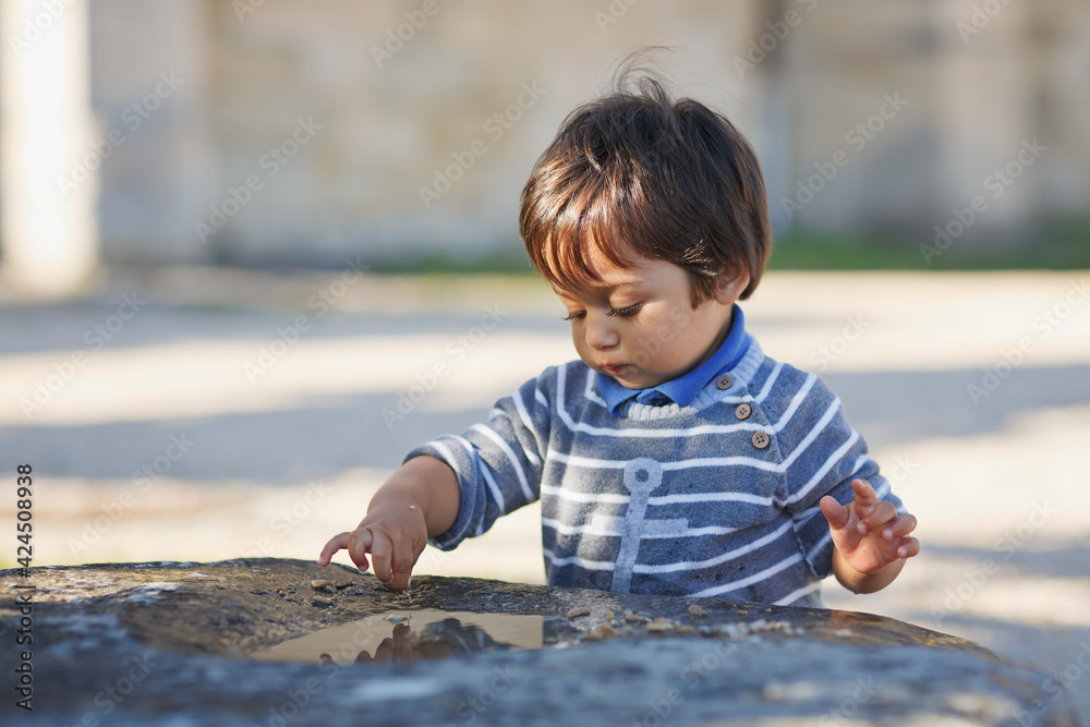 Portrait of a little eastern handsome baby boy playing outdoor in the park Portrait of a little eastern handsome baby boy playing outdoor in the park