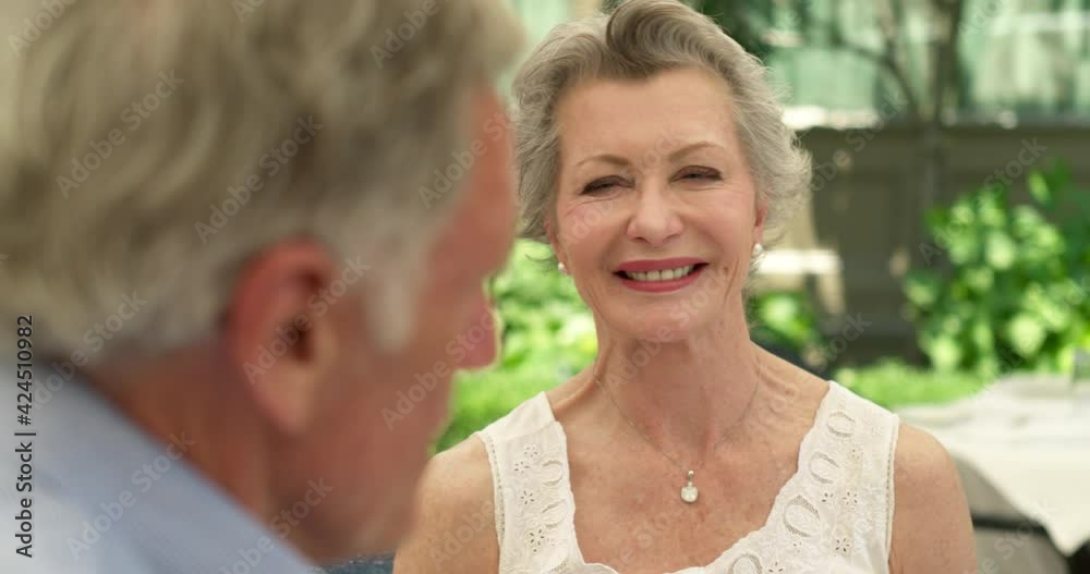 Beautiful senior woman talking in an outdoors restaurant Beautiful senior woman talking in an outdoors restaurant