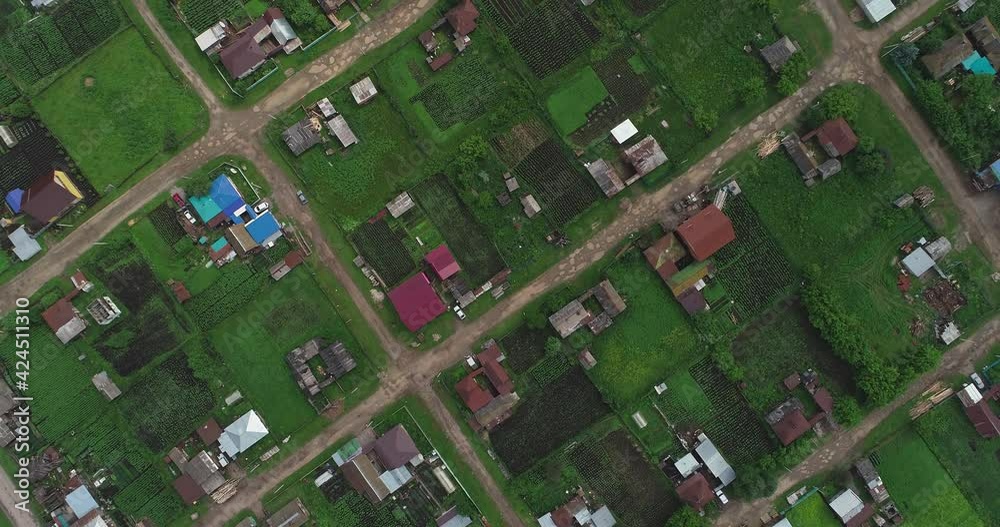Large old poor village with private houses with vegetable gardens at summer cloudy day. Aerial drone from above view Large old poor village with private houses with vegetable gardens at summer cloudy day. Aerial drone from above view