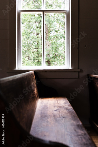 sunlight spilling through a church window, lighting the pew