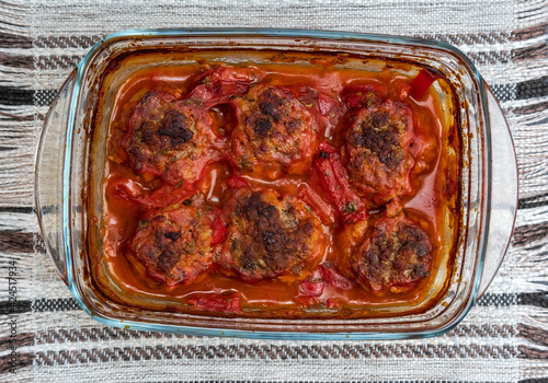 Meatballs baked in form in the oven with a gravy of tomato paste, tomatoes, onions and spices.