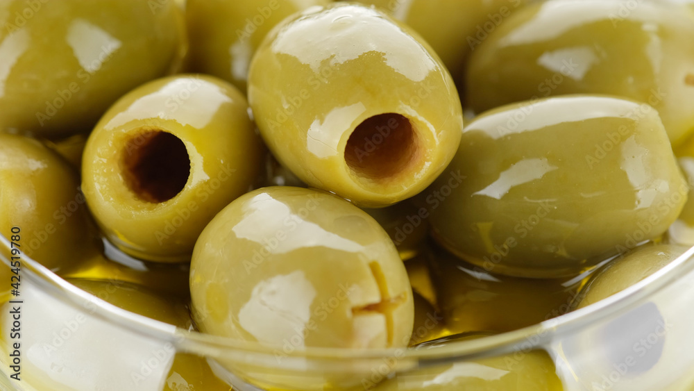 pitted green olives close up on white background pitted green olives close up on white background