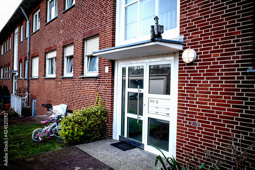 door at the entrance to a red apartment building