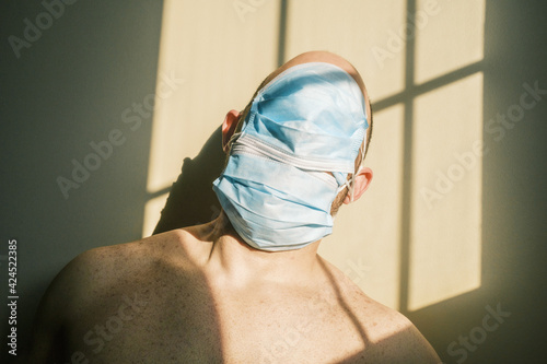 desperate person with mask at home due to the closure of the pandemic in times of covid. quarantine