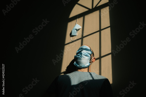 desperate person with mask at home due to the closure of the pandemic in times of covid. quarantine