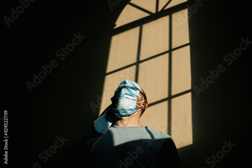 desperate person with mask at home due to the closure of the pandemic in times of covid. quarantine