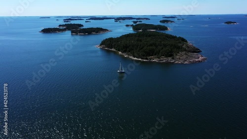 Aerial view over a Sailboat in the archipelago of sunny Finland - tilt, drone shot photo