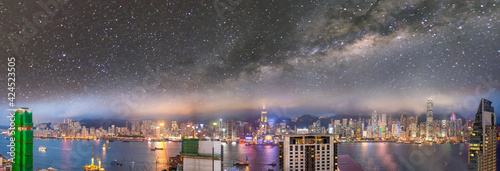 Amazing night panoramic view of Hong Kong skyline from Kowloon Tower with starry sky