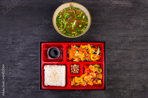 Lunch box with chicken soup and seafood stewed with vegetables and sesame