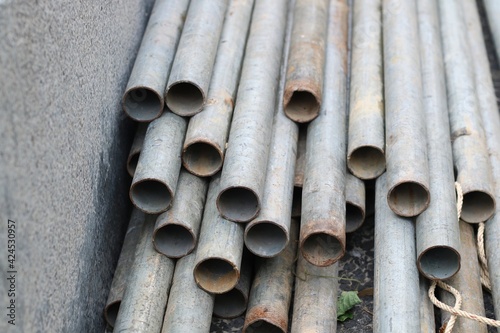 Steel pipes on the floor at construction site. Industrial and object concept.