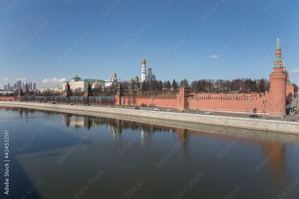 Beautiful Moscow Kremlin on the river bank. High towers. Sunny day. Ancient architecture. Center of Moscow.