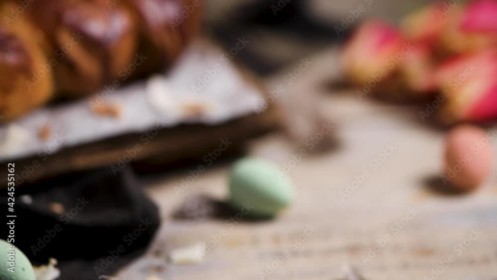 Portuguese traditional Easter cake. Folar with eggs on easter table. Blossom tulips, colorful painted eggs and feathers Portuguese traditional Easter cake. Folar with eggs on easter table. Blossom tulips, colorful painted eggs and feathers