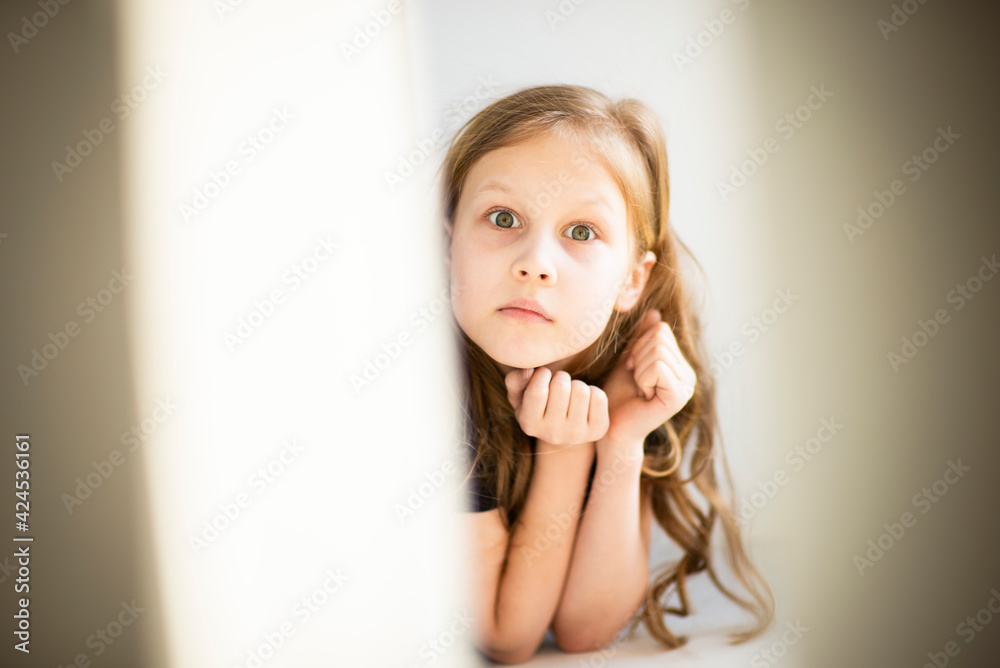 Happy childhood. Emotional portrait of a child in pastel colors, in sunlight, selective focus Happy childhood. Emotional portrait of a child in pastel colors, in sunlight, selective focus