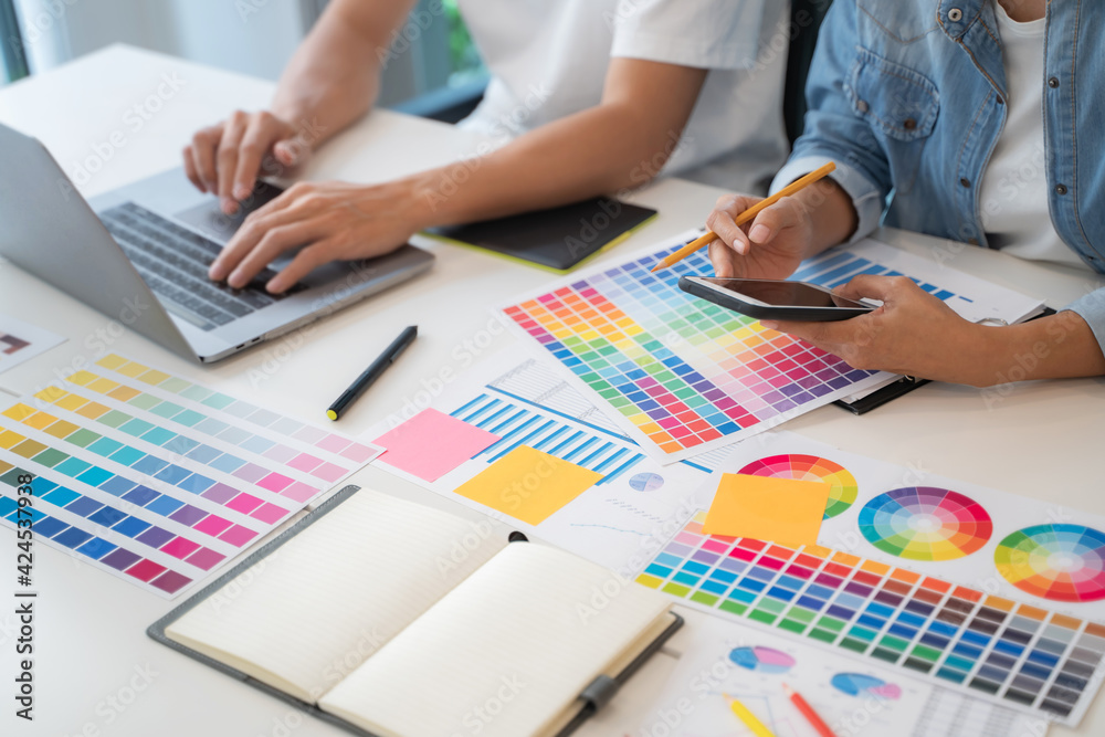 Group of startup team coworking with new creative project plan.. Group of startup team coworking with new creative project plan..