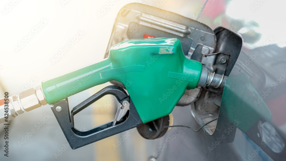 Green nozzle pump Gun petrol from oil pump in the car tank to refueling Green nozzle pump Gun petrol from oil pump in the car tank to refueling