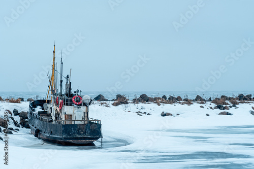 Old tugboat in winter parking 
