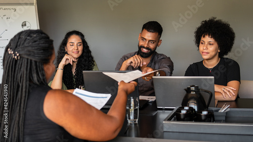 black business woman giving resume to employee at job interview..