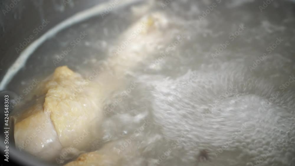 top view of boiling chicken broth in steel pan on glass ceramic cooker top view of boiling chicken broth in steel pan on glass ceramic cooker