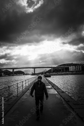 Man walking in the darsena de Portu in Barakaldo Bilbao