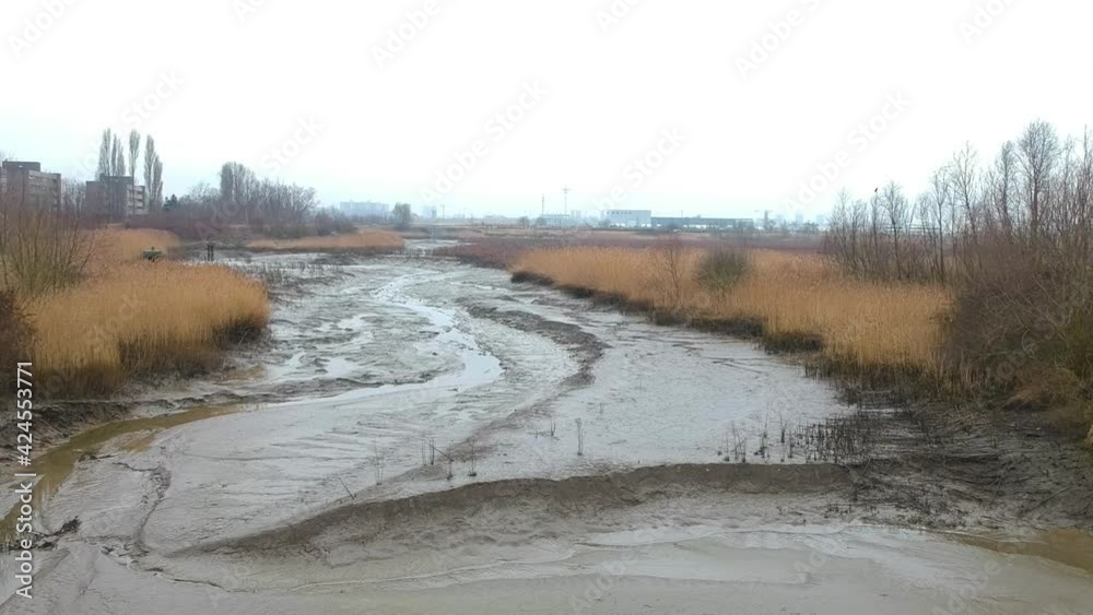 Dried river bed on misty day in drone truck left shot Dried river bed on misty day in drone truck left shot