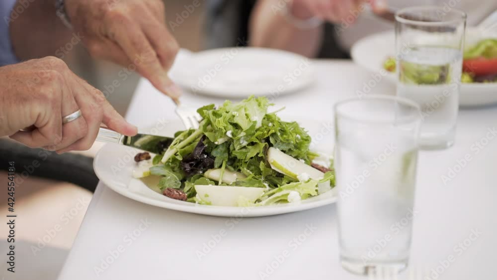 Senior person having meal in an outdoors restaurant Senior person having meal in an outdoors restaurant