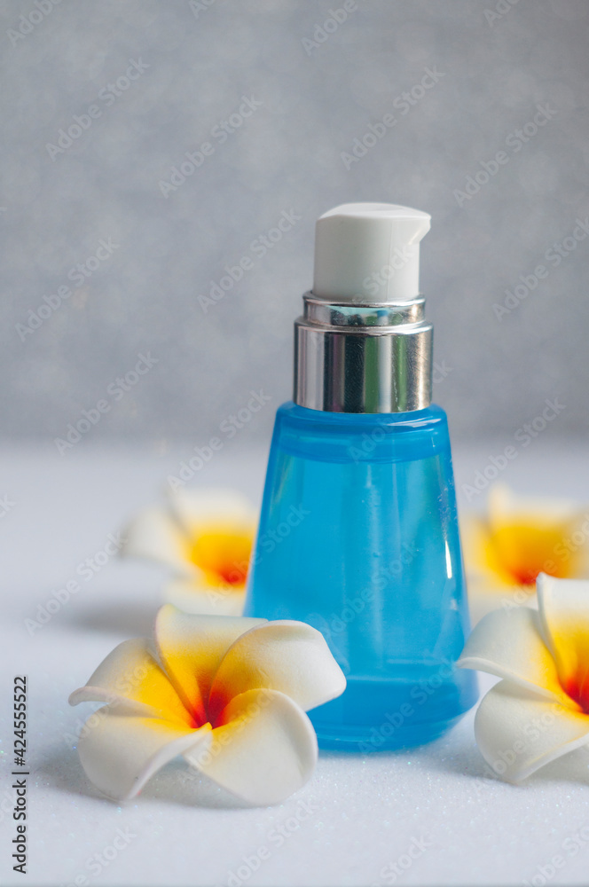 moisturizing cream cosmetic in a bottle for skin care with mango flowers moisturizing cream cosmetic in a bottle for skin care with mango flowers