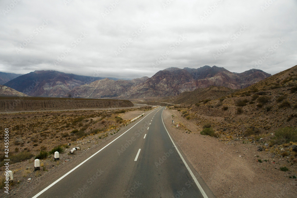 Road trip. Traveling along the asphalt highway across the arid desert and rocky mountains