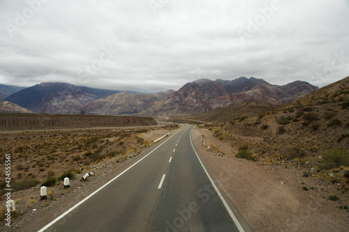 Road trip. Traveling along the asphalt highway across the arid desert and rocky mountains