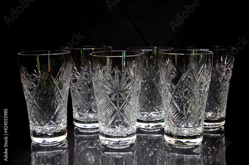 6 empty crystal bowls symmetrically on a black background 