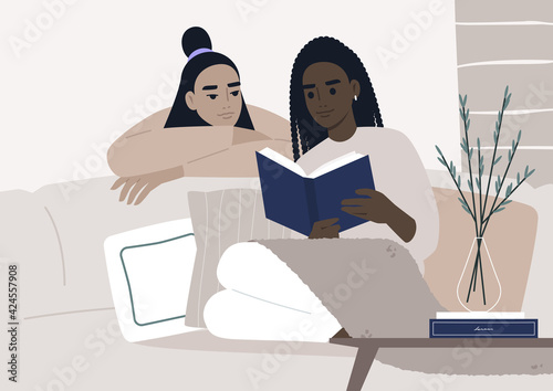 Weekend leisure activities, a lesbian couple reading a book together in the living room, cozy domestic life during the lockdown