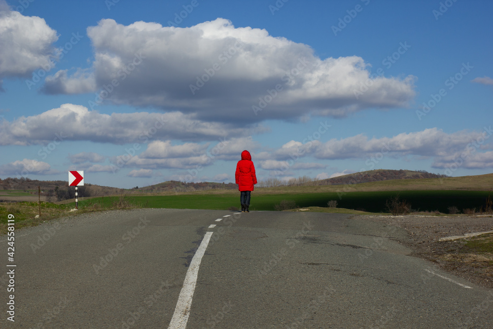 Asphalt road with a white dividing strip going beyond the horizon. Blue ...