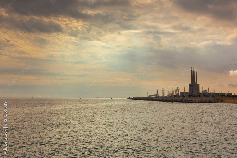 Seascape in the Mediterranean Sea with views of an old disused Thermal Power Plant for the production of electricity