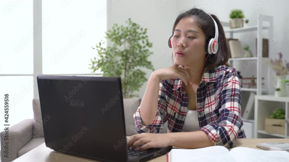 student wearing earphones is learning online student wearing earphones is learning online