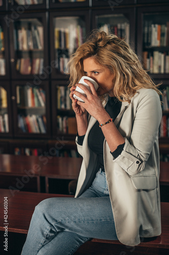Woman drinking coffee in the office