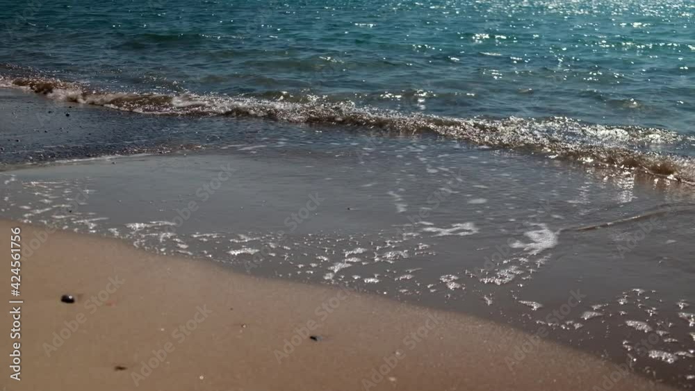 Splashing waves of sea and sandy beach. Close-up of evening surf waves Splashing waves of sea and sandy beach. Close-up of evening surf waves