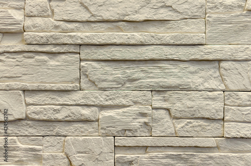 Tile for cladding a house under a stone.