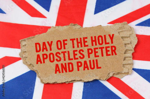 Against the background of the flag of Great Britain lies cardboard with the inscription - Day of the holy apostles