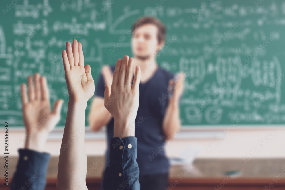 © Mihail - students at school with raised handsб classroom learning together © Mihail - students at school with raised handsб classroom learning together