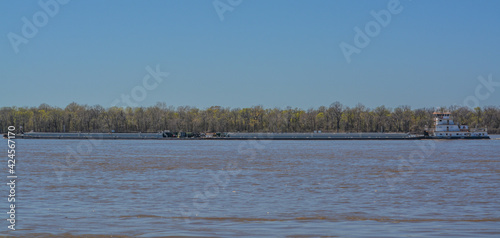 A Tug Boat is pushing Barges down the Mississippi River past Millington in Shelby, Tennessee photo