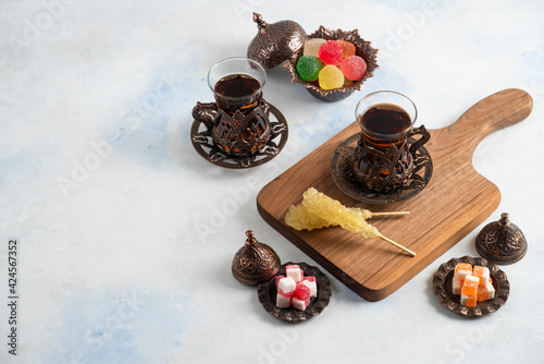 Turkish tea set. Fragrant tea and sweet candies on white background
